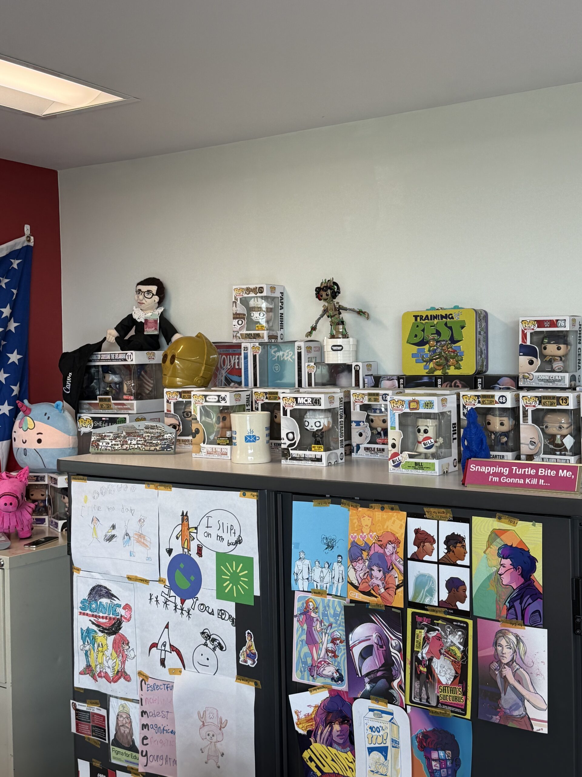 Shelves in a room crowded with Pop figures, plush toys, handmade art, and colorful drawings, creating a playful, creative mood